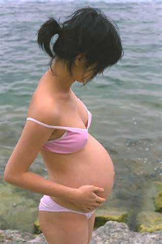 Miho is a cute Asian with a huge pregnant belly and a nice hairy bush.