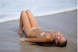 Attractive teen babe Aria A Met Art strips on the beach and shows her ...
