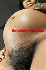 Pregnant black woman with a thick hairy pussy and big tits
