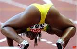 female Jamaican athlete getting ready to sprint.