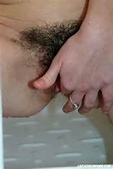 ... so she starts finger fucking her hairy pussy to orgasm in the shower