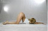 Naked gymnast doing her stretching workout