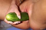 ... and sexy, petite figure as she toys her pussy with a huge cucumber
