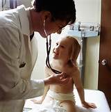 Description Doctor uses a stethoscope to examine a young patient.JPEG
